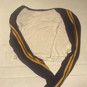 white crop top with blue sleeves and yellow stripes